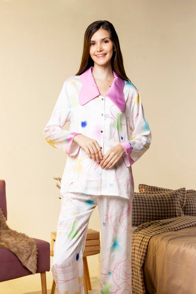 A woman wearing a silk long sleeve pajama set
