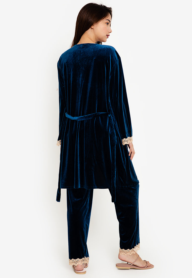 A woman standing and wearing velvet robes