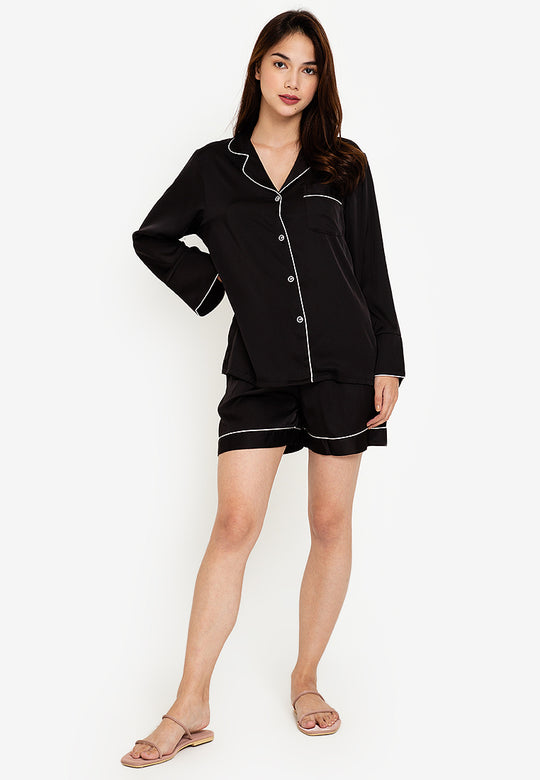 A woman wearing a long sleeve shorts set
