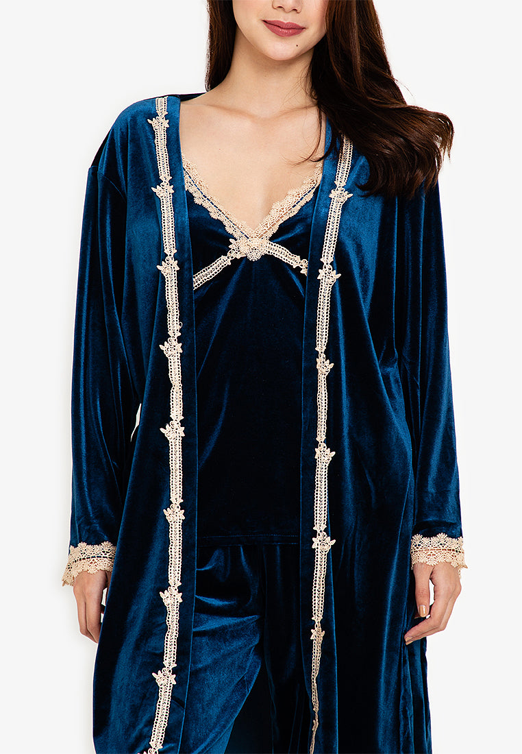 A woman standing and wearing velvet robes