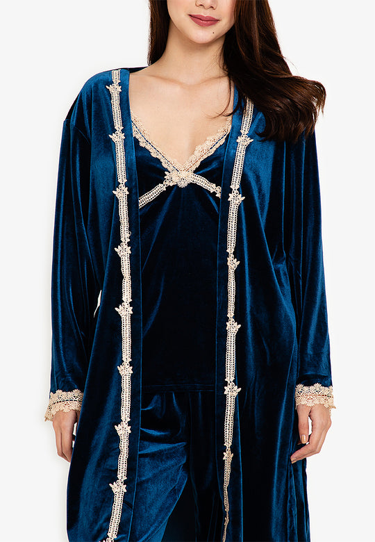 A woman standing and wearing velvet robes