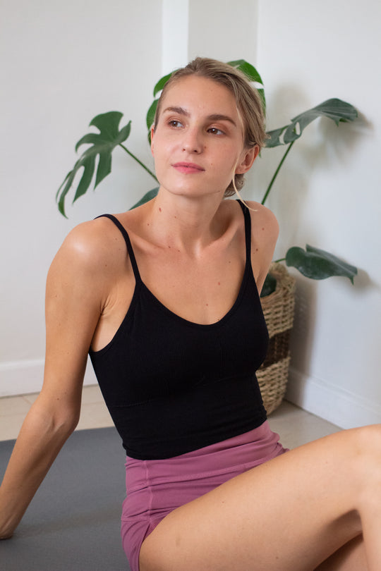 woman front facing wearing a black bralette