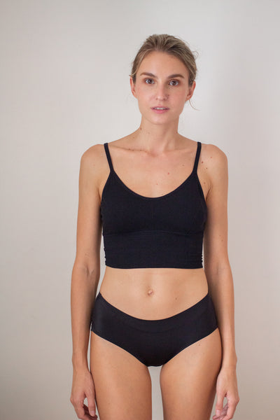 woman front facing wearing a black bralette