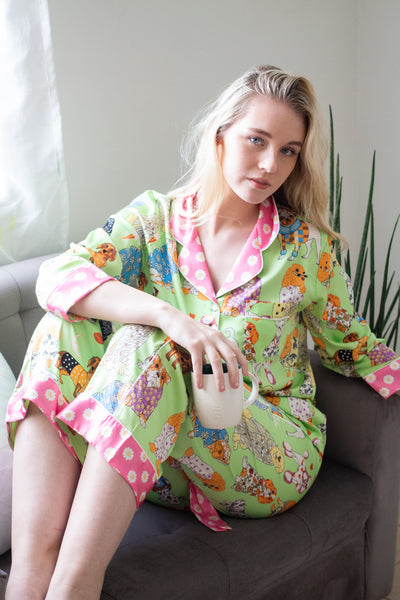 A woman sitting and wearing silk long sleeve pajama set