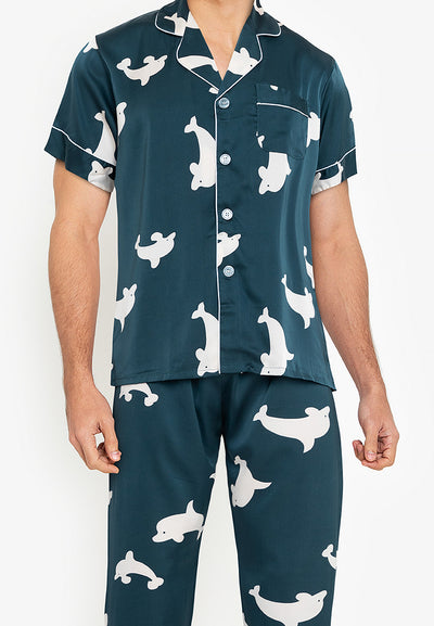 A man wearing a silk short sleeve pajama set