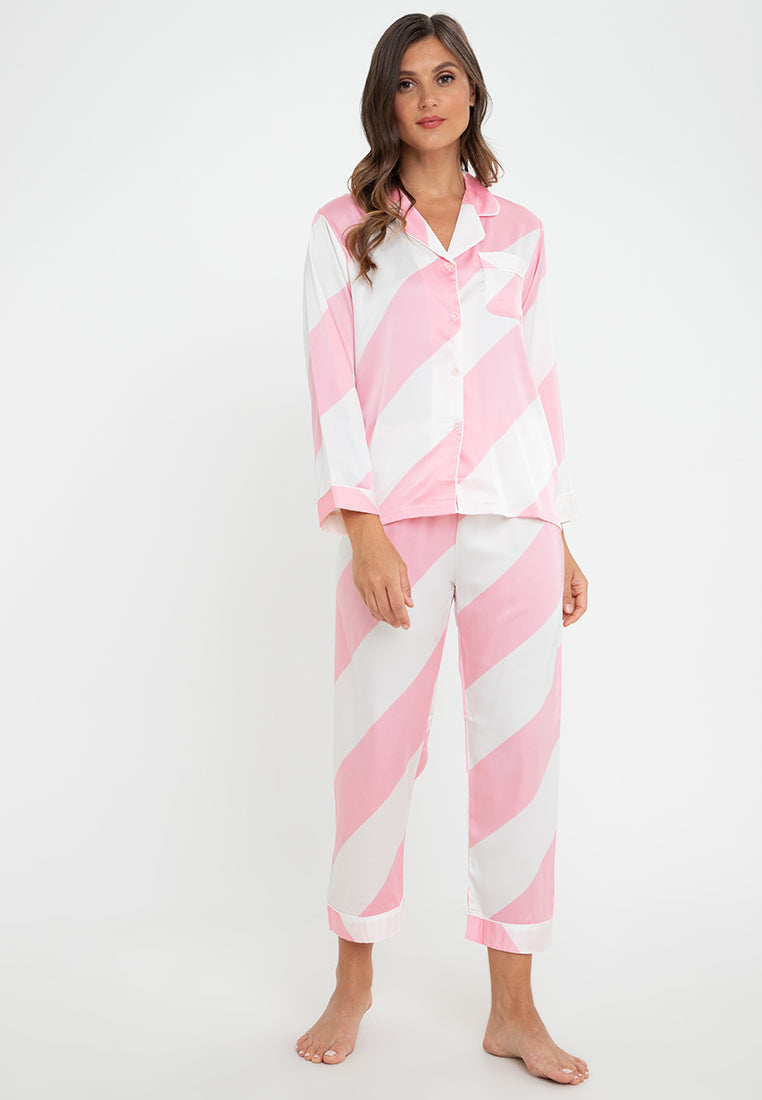 A woman wearing a silk long sleeve pajama set