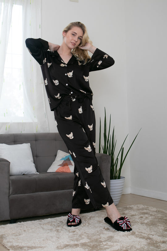 A woman wearing a silk long sleeve pajama set