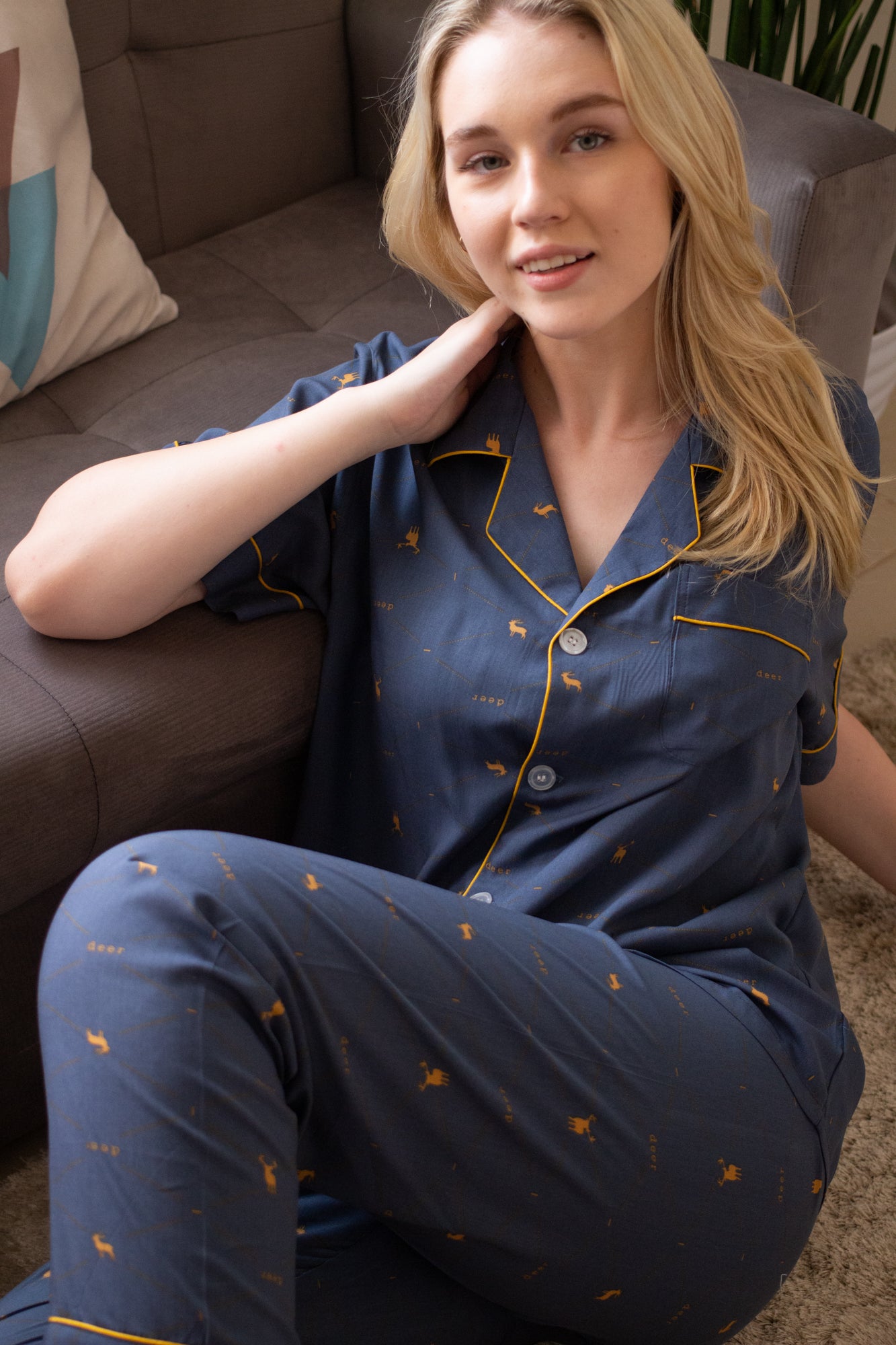 A woman sitting and wearing a cotton short sleeve pajama set