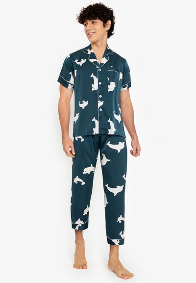 A man wearing a silk short sleeve pajama set