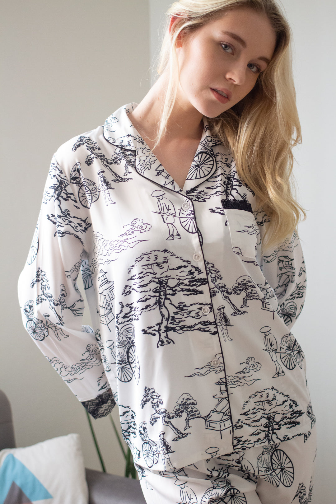 Woman standing up and wearing long sleeves top and pajama