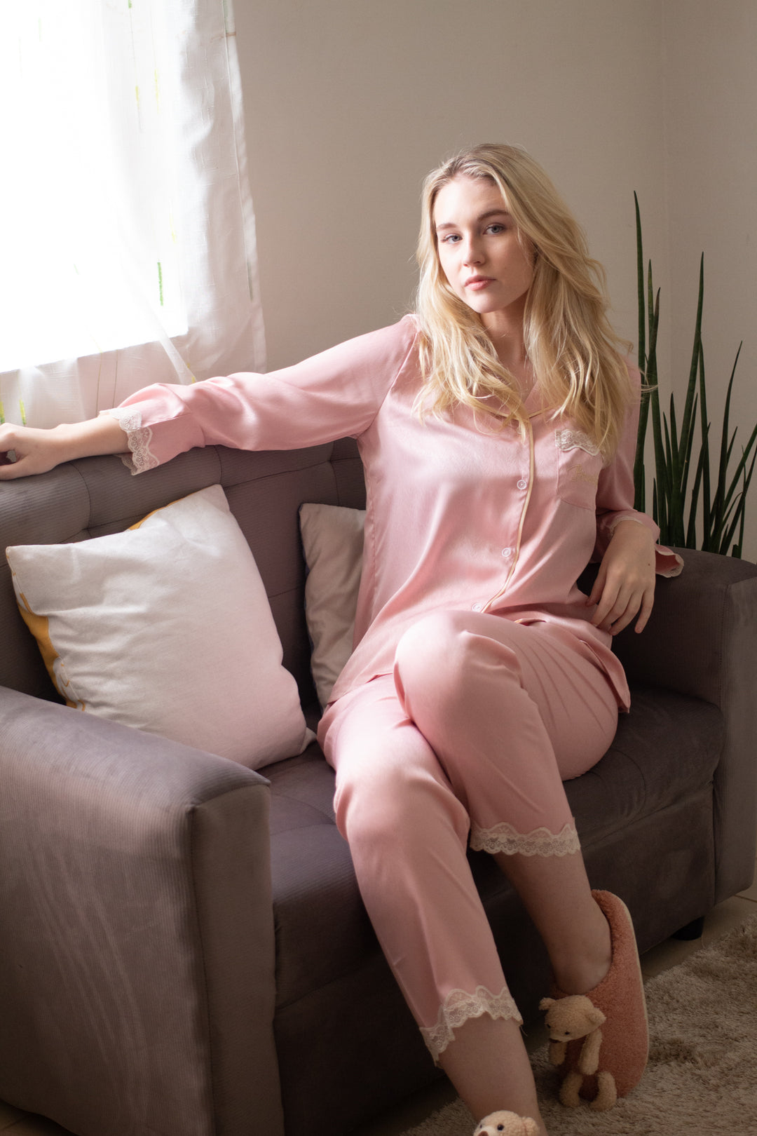 A woman wearing a silk long sleeve pajama set