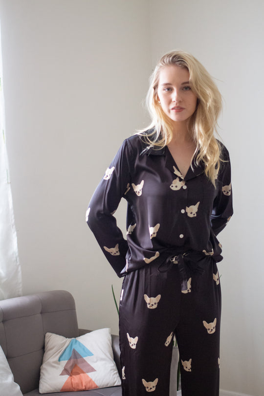 A woman wearing a silk long sleeve pajama set