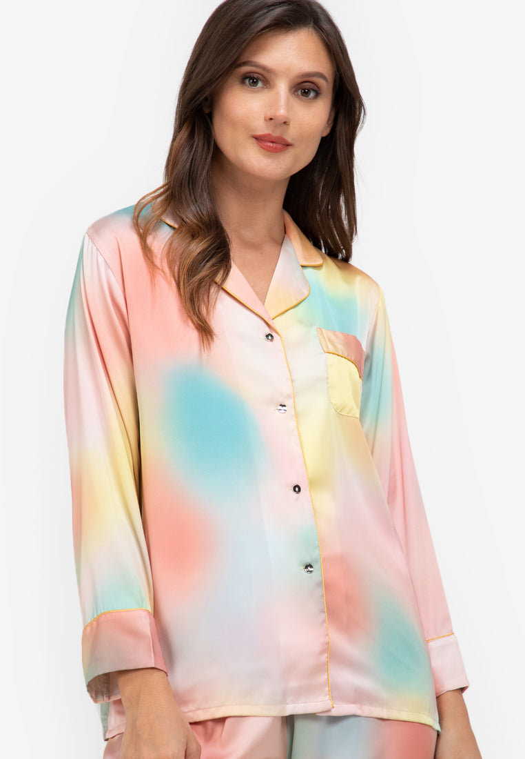 A woman wearing a silk long sleeve pajama set