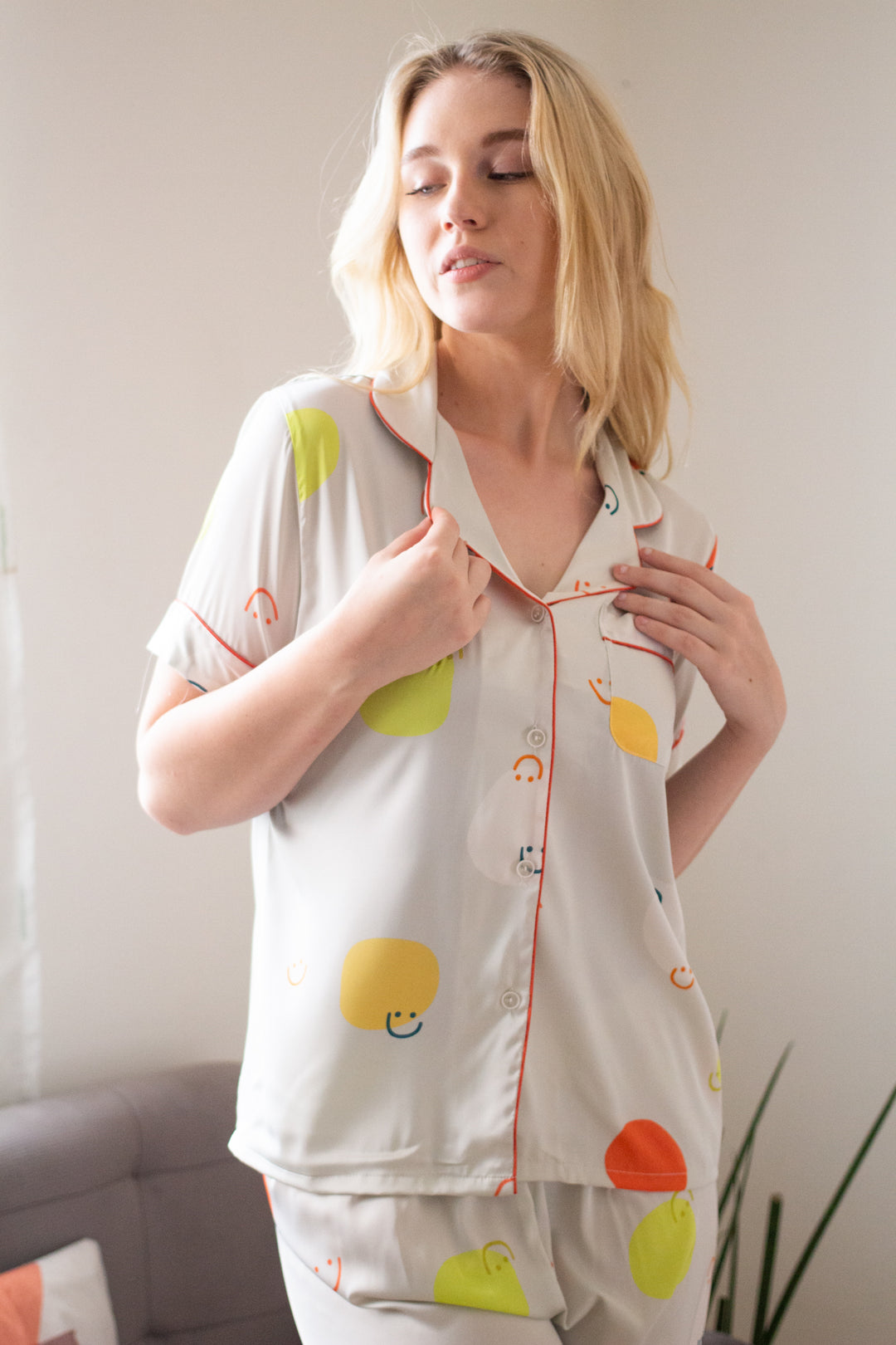 A woman wearing a silk short sleeve pajama set