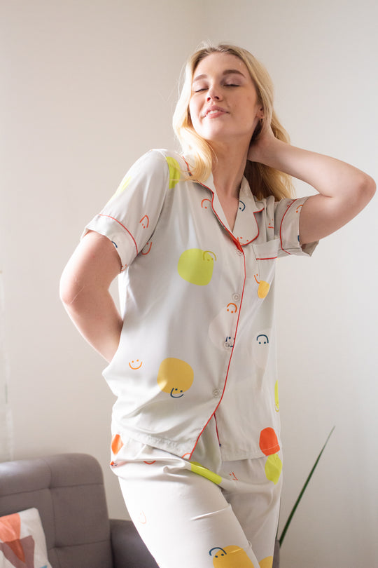 A woman wearing a silk short sleeve pajama set