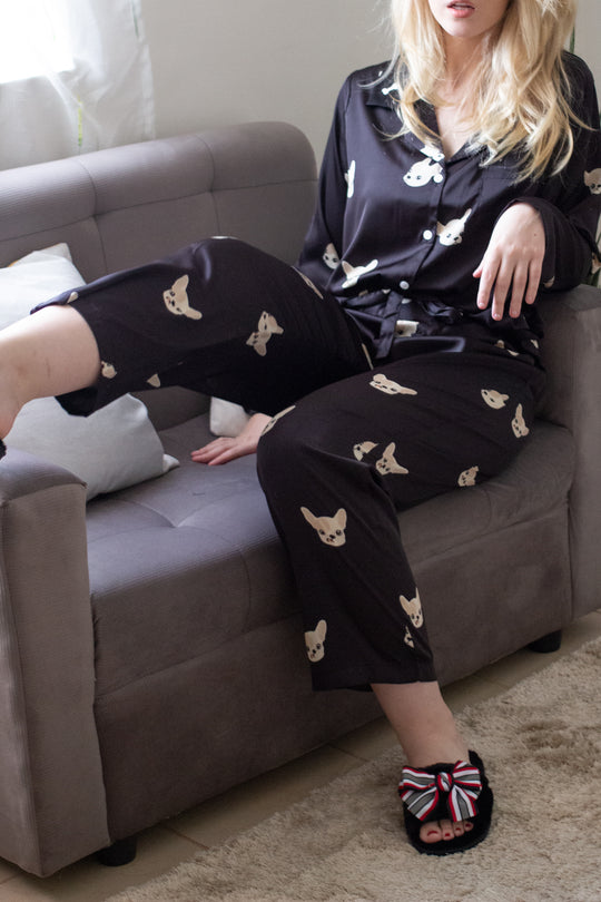 A woman wearing a silk long sleeve pajama set