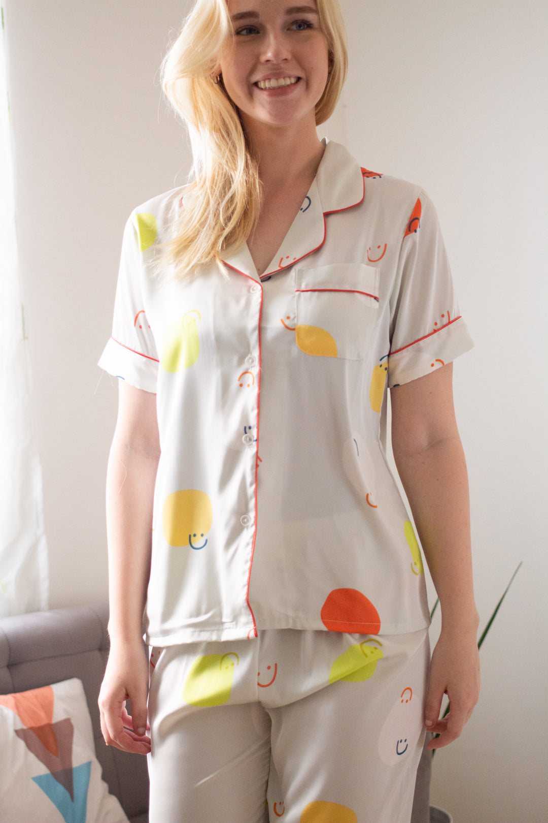 A woman wearing a silk short sleeve pajama set