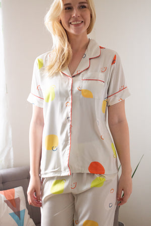 A woman wearing a silk short sleeve pajama set