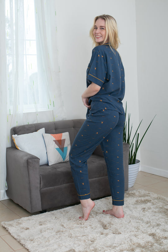 A woman standing and wearing a cotton short sleeve pajama set