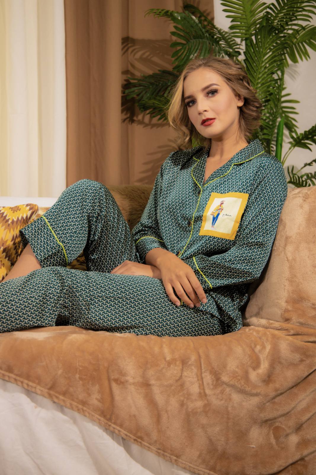 A woman sitting and wearing a Silk long sleeve pajama set