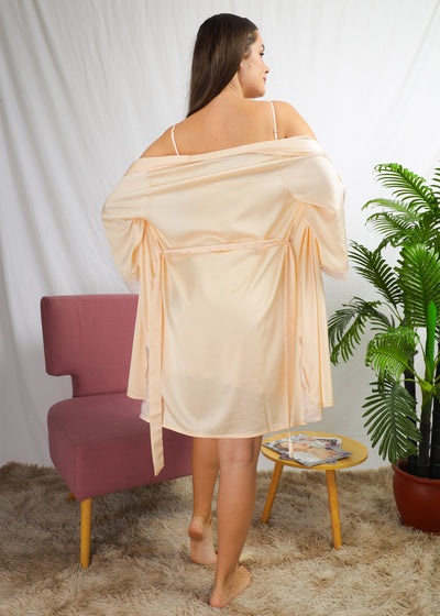 A woman wearing a slip dress top in a robe