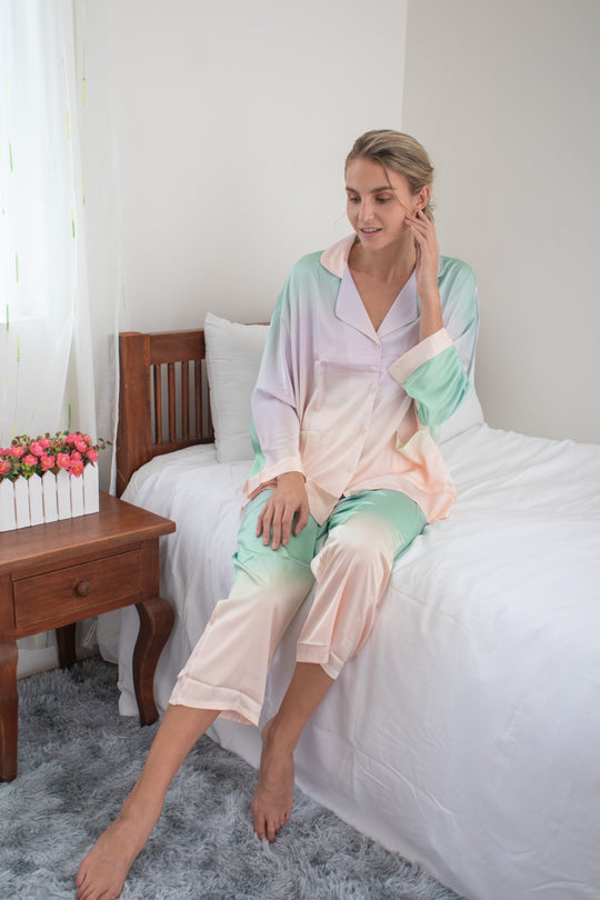 A woman wearing a silk long sleeve pajama set