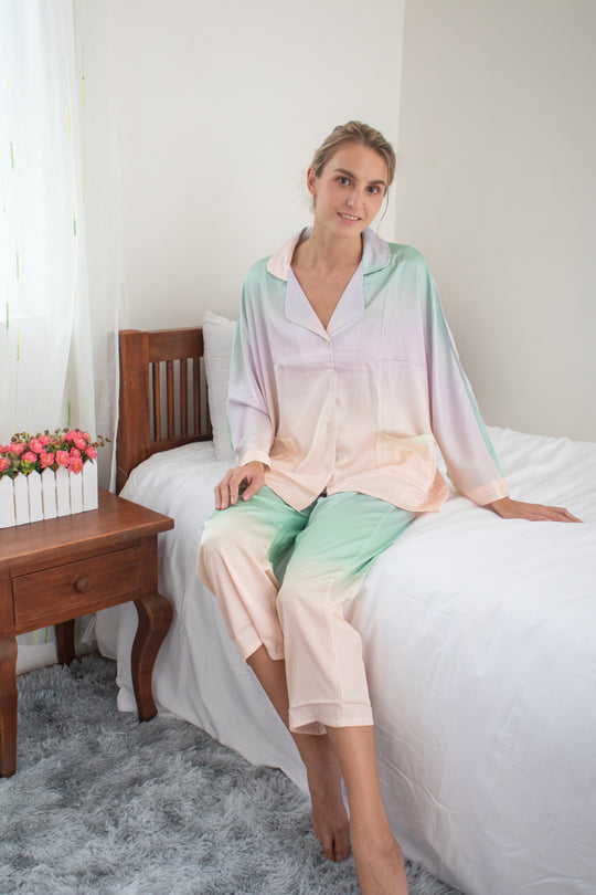 A woman wearing a silk long sleeve pajama set