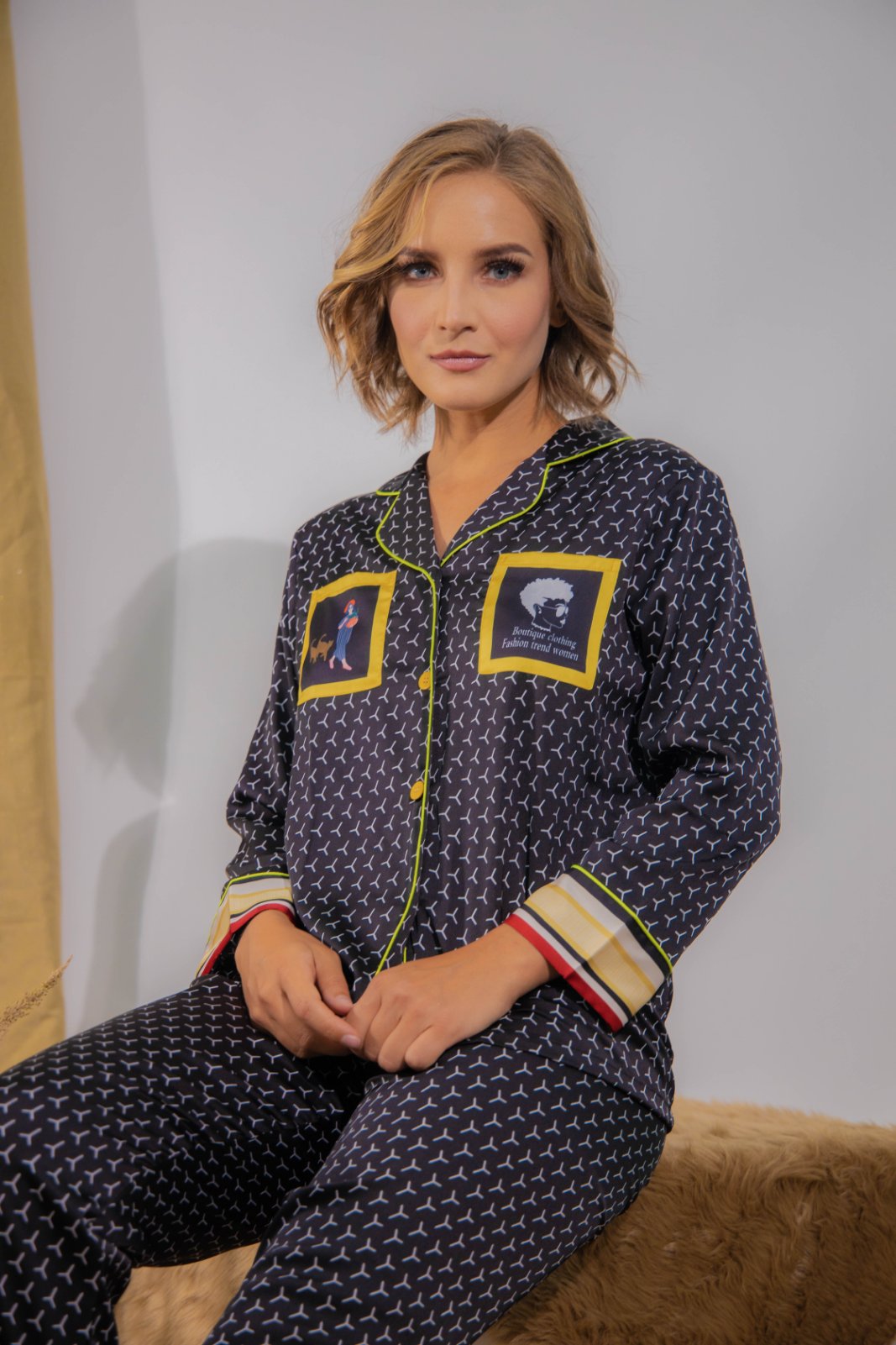 A woman sitting and wearing a Silk long sleeve pajama set
