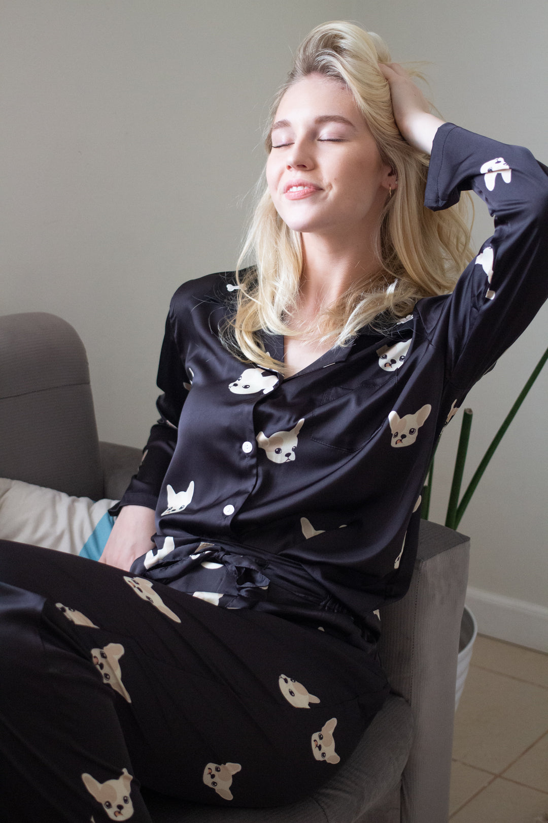 A woman wearing a silk long sleeve pajama set