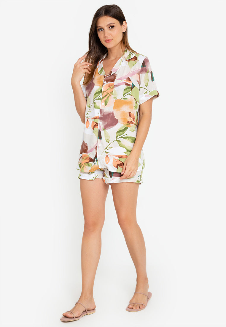 A woman standing and wearing a short sleeve floral cotton pajama set