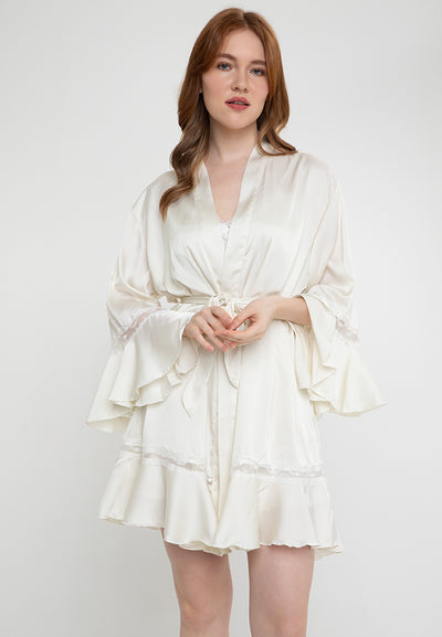 A woman wearing a robe in a slip dress