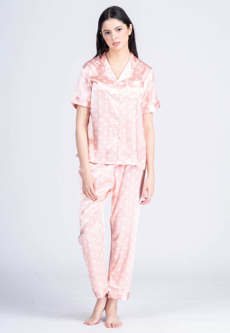 A woman wearing a silk short sleeve pajama set