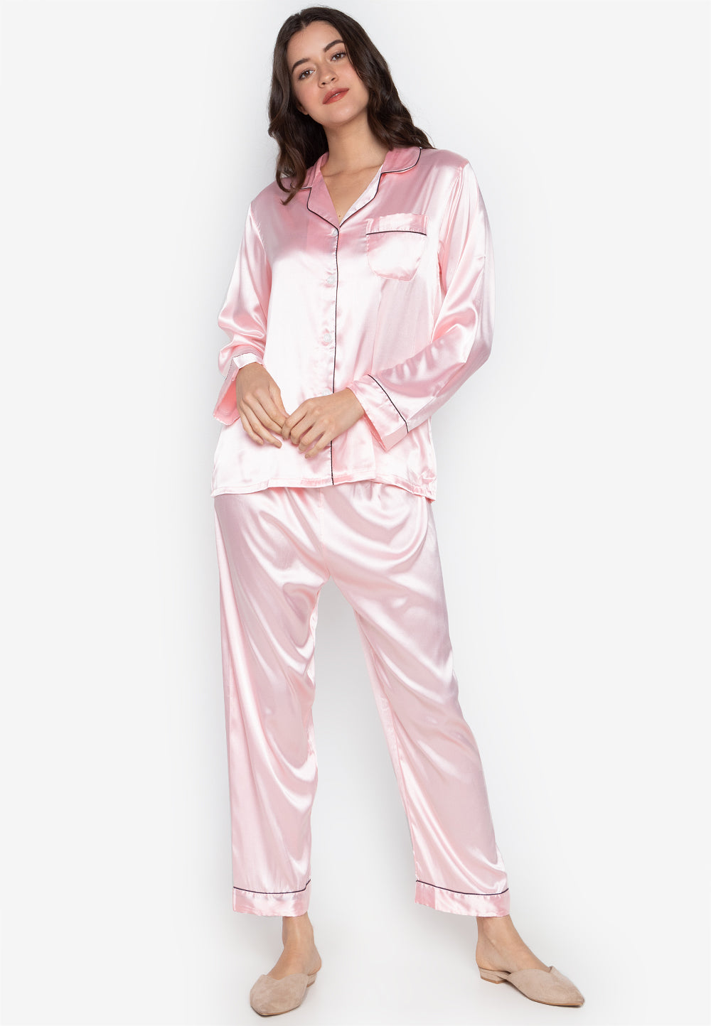 A woman wearing a silk long sleeve pajama set