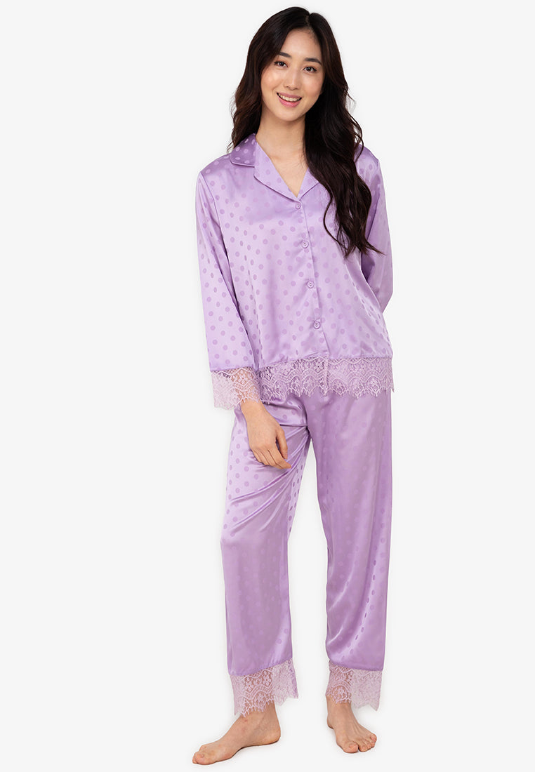 A woman wearing a silk long sleeve pajama set