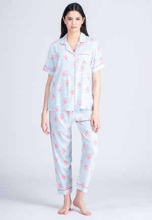 A woman wearing a cotton short sleeve pajama set with design graphic