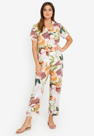A woman standing and wearing a short sleeve floral cotton pajama set