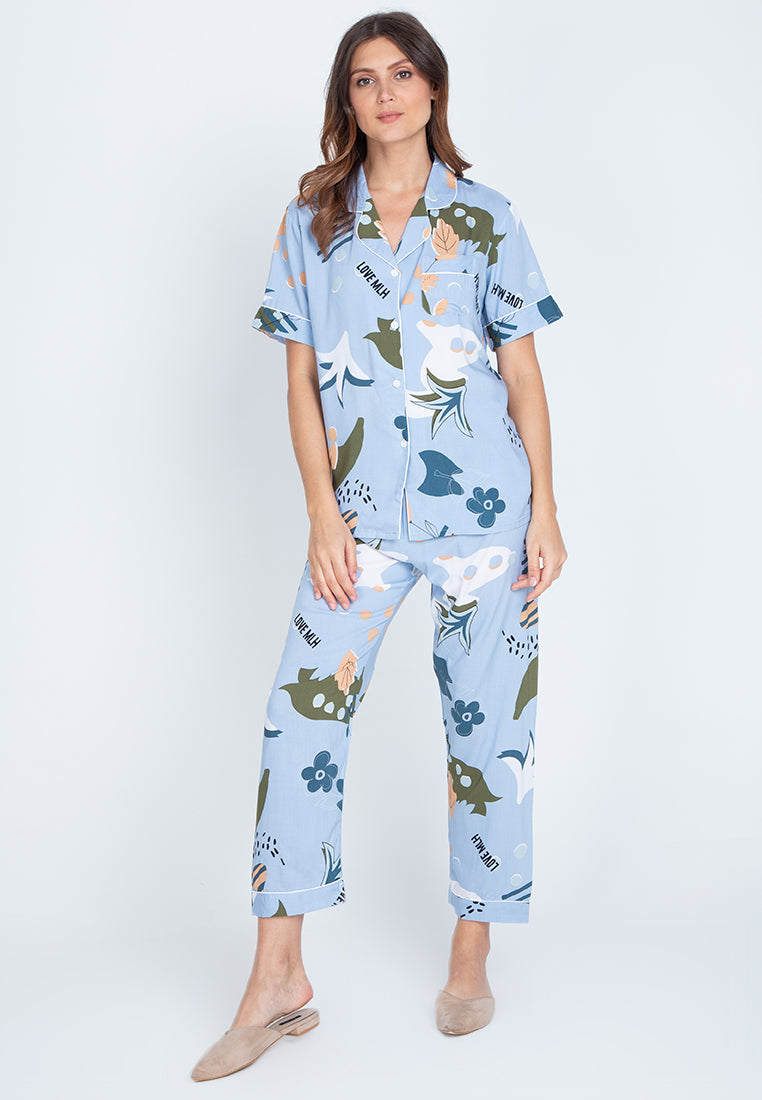A woman standing and wearing a short sleeve floral cotton pajama set