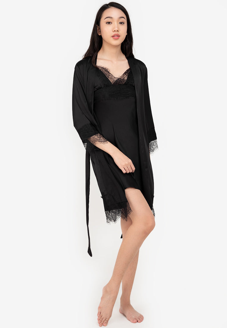 A woman wearing a slip dress in a robe black