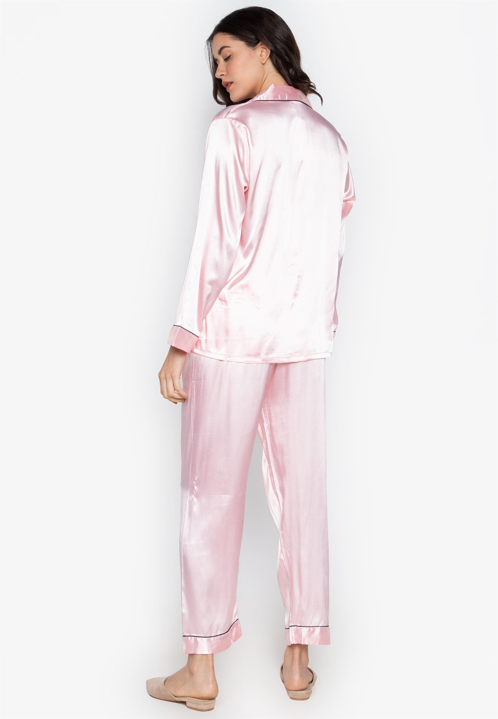 A woman wearing a silk long sleeve pajama set