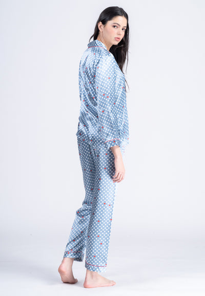 A woman standing and wearing a long sleeve pajama set
