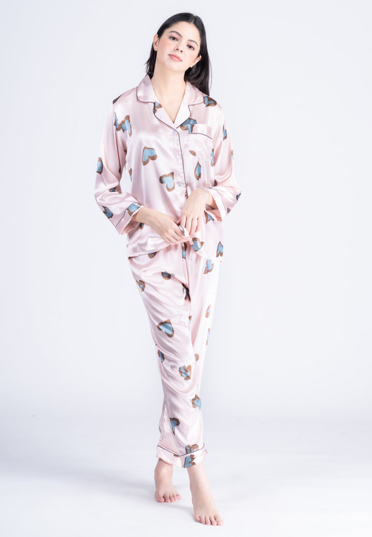 A woman wearing a silk long sleeve pajama set