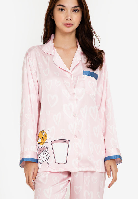 A woman wearing a silk long sleeve pajama set