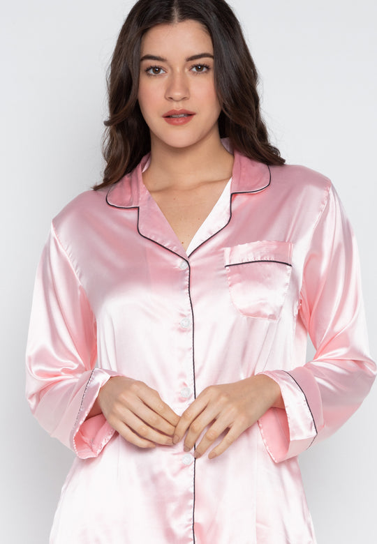 A woman wearing a silk long sleeve pajama set