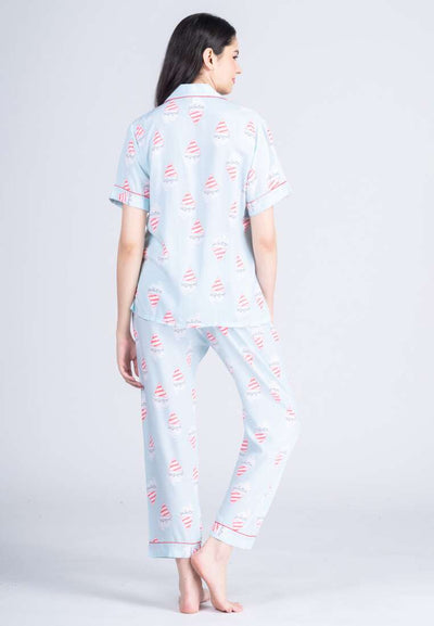 A woman wearing a cotton short sleeve pajama set with design graphic