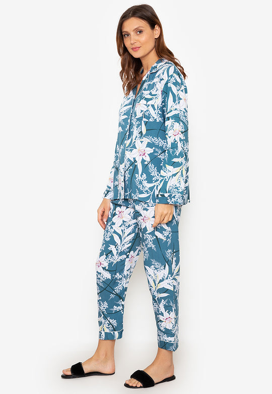 A woman standing and wearing a long sleeve pajama set