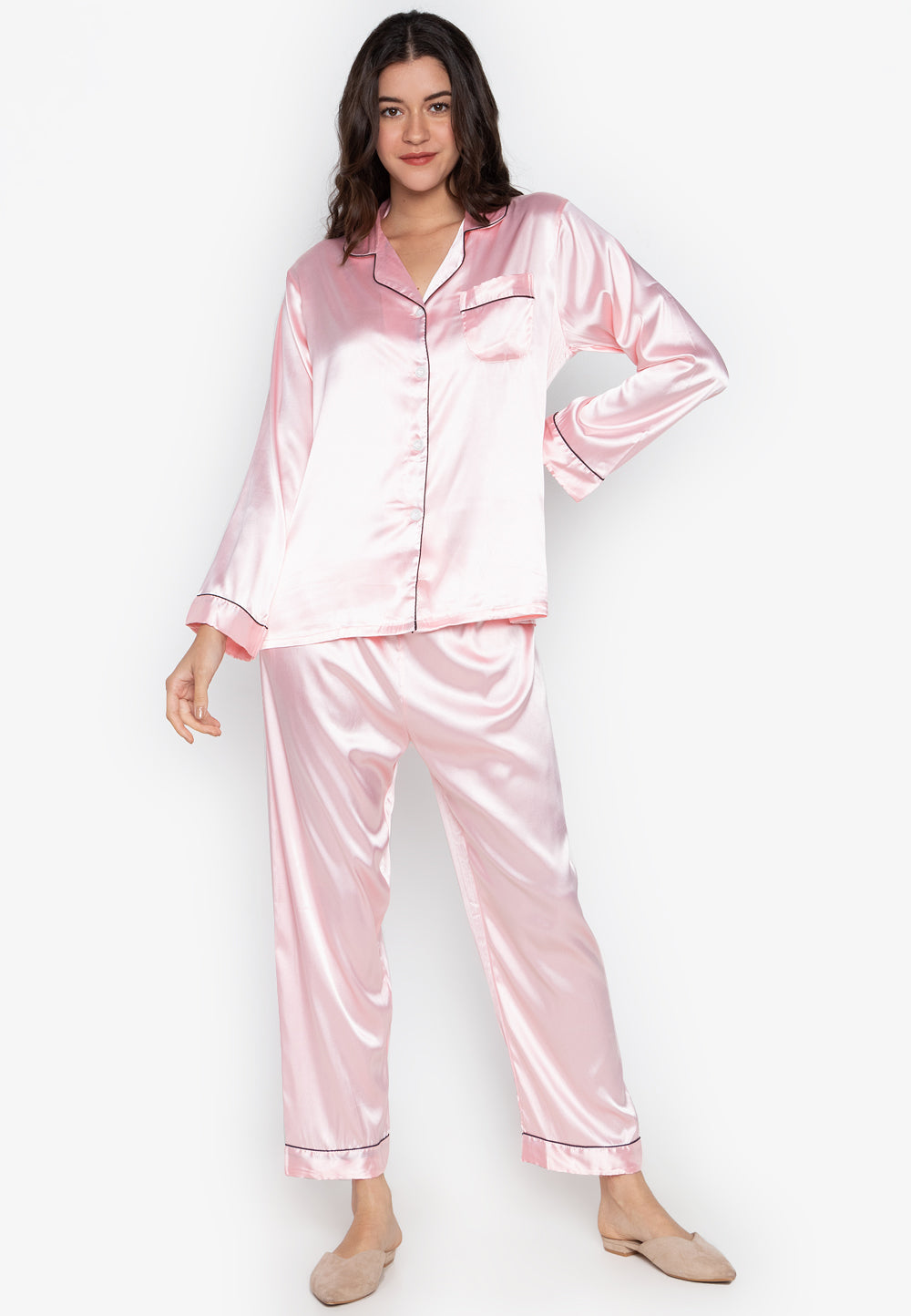 A woman wearing a silk long sleeve pajama set
