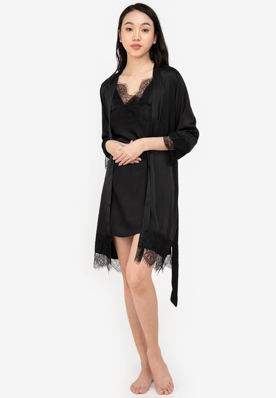 A woman wearing a slip dress in a robe black