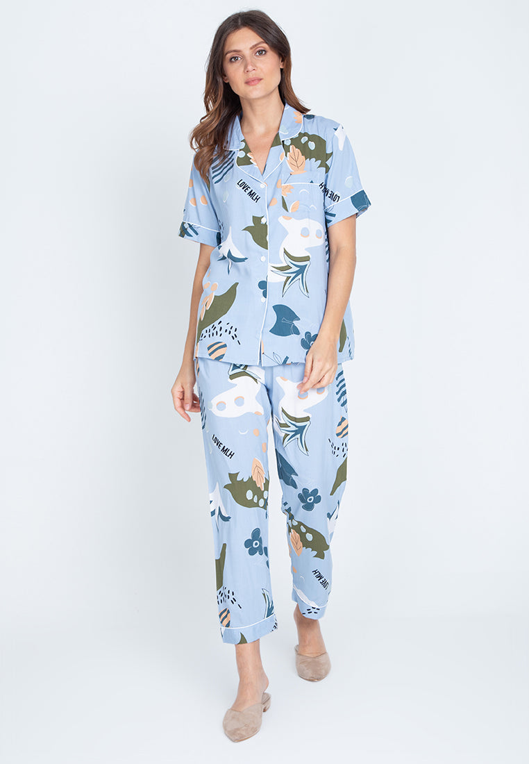 A woman standing and wearing a short sleeve floral cotton pajama set