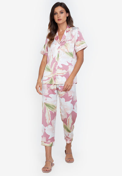 A woman wearing a silk short sleeve pajama set