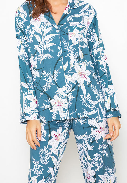 A woman standing and wearing a long sleeve pajama set